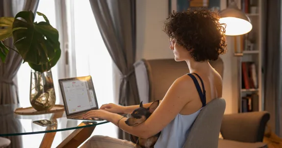 this woman is working from home using best earbuds for work from home