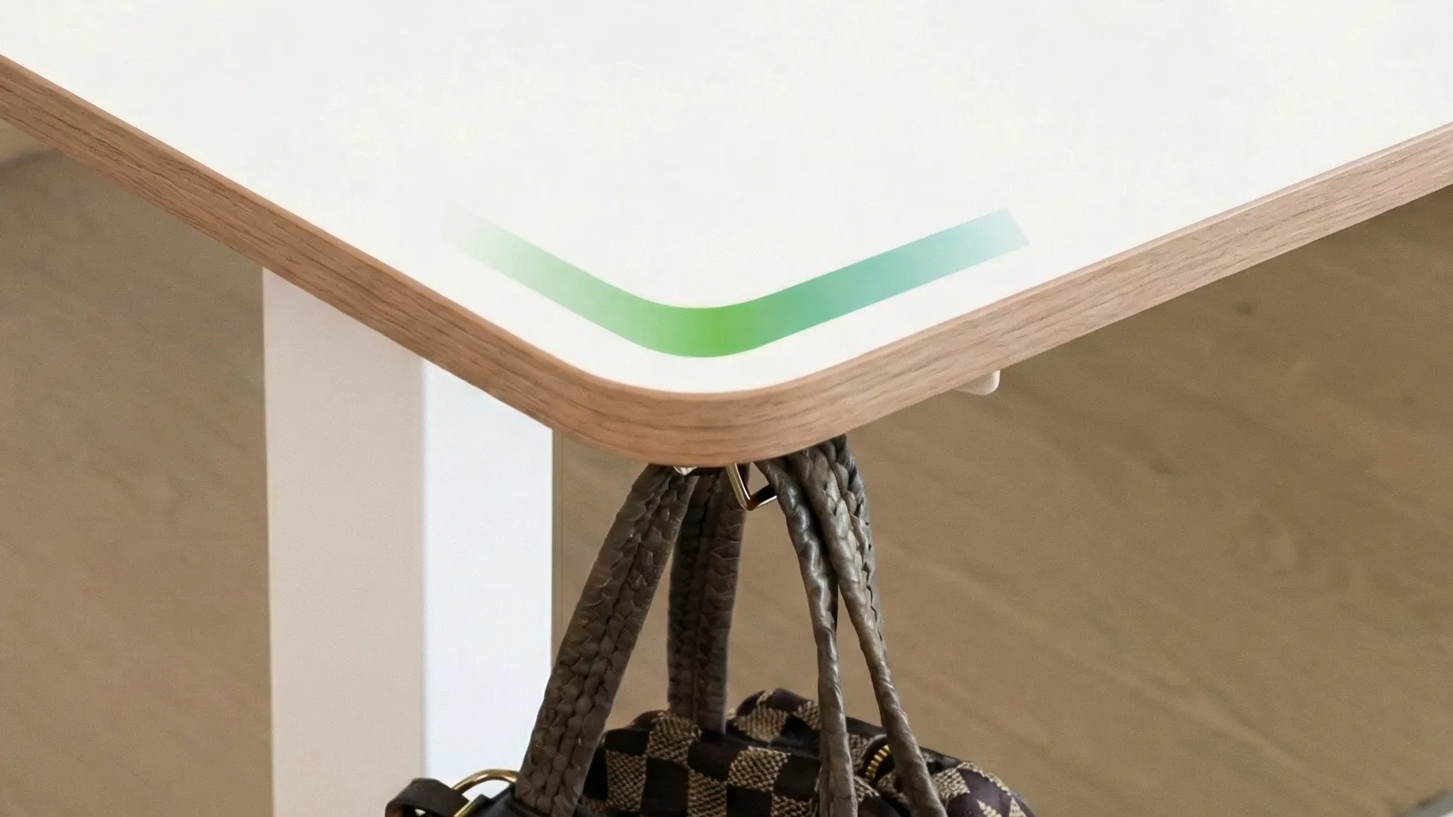 A heavy bag suspended from the corner of the desk demonstrates its impressive load-bearing capacity.