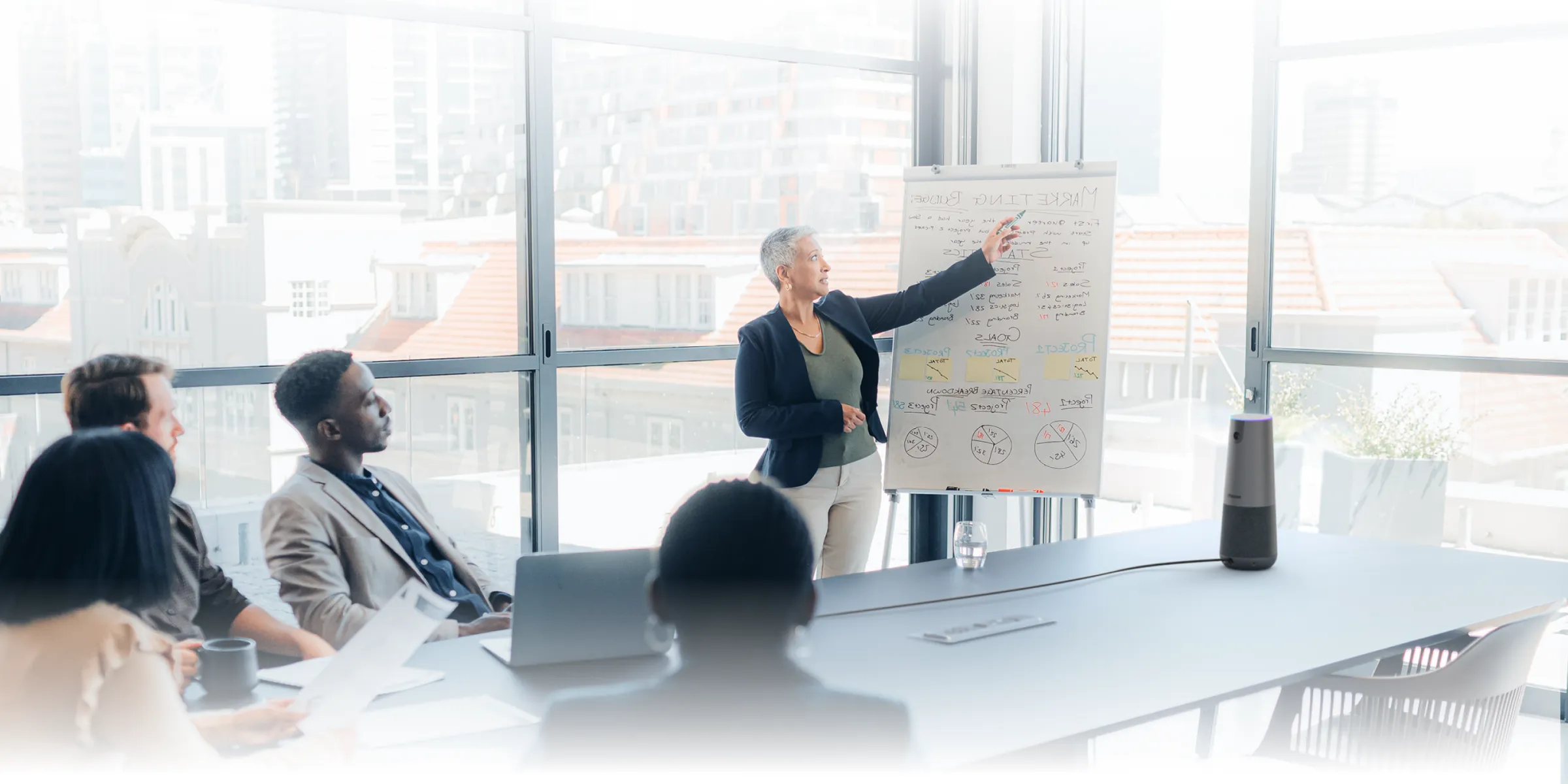 Several people in a conference room using Nearity 120 Max Conference Camera for office in a meeting