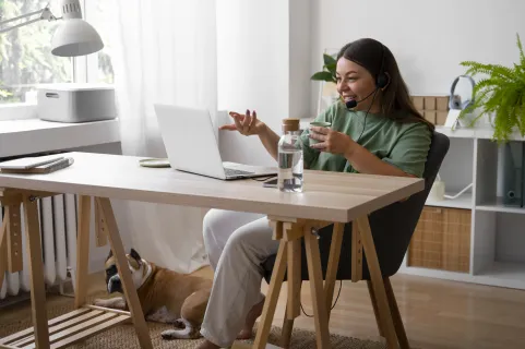 Woman using a wireless headset for remote work, enjoying clear calls and comfort.