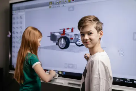 A diverse group of students and their teacher excitedly using one of the best whiteboards for the classroom