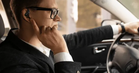 開放型イヤホンNearity MemPod Fit 2で通話しながら運転している男