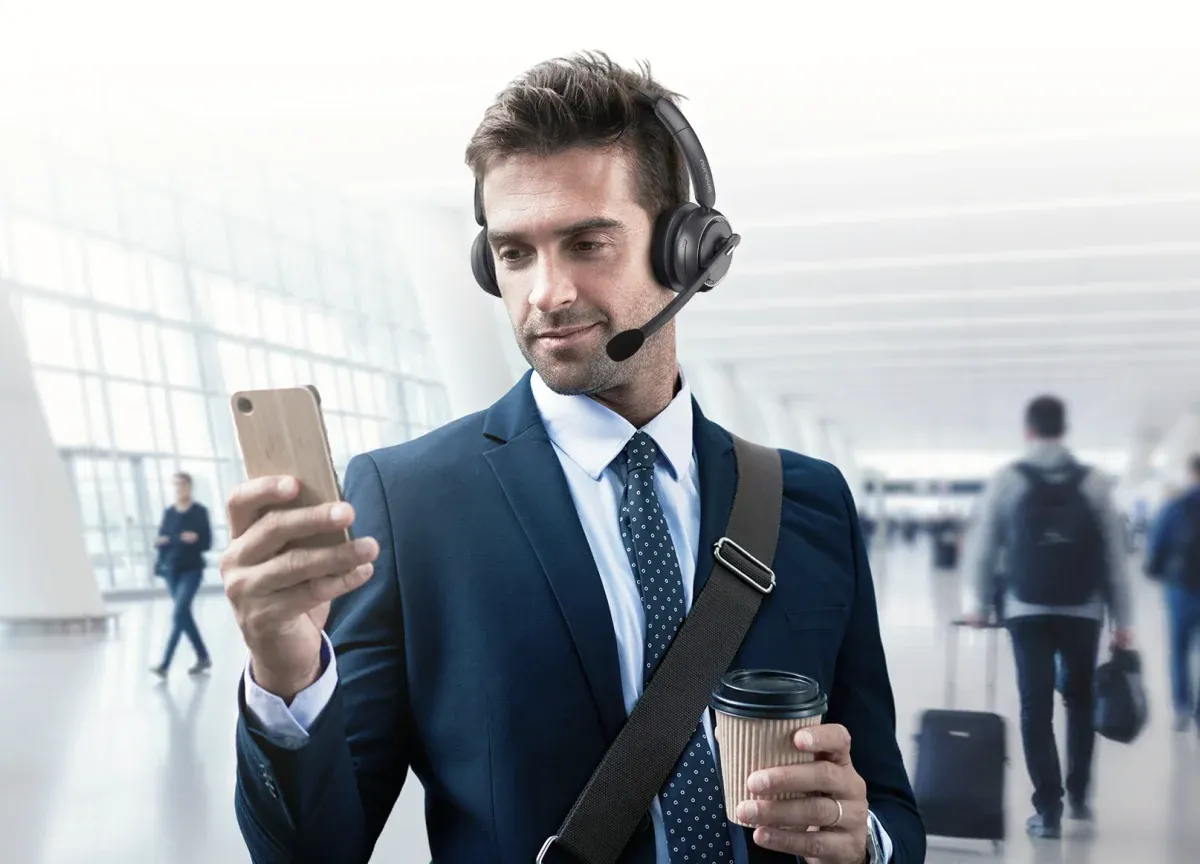 bluetooth noise cancelling headset with mic wearing headset at office for business trip