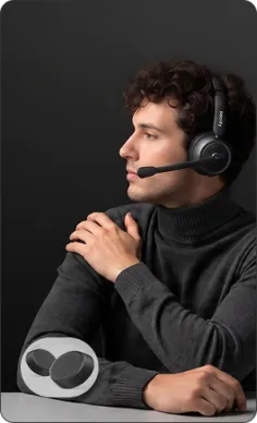 Smiling professional woman comfortably wearing over ear noise cancelling headphones, ideal headphone for call center.