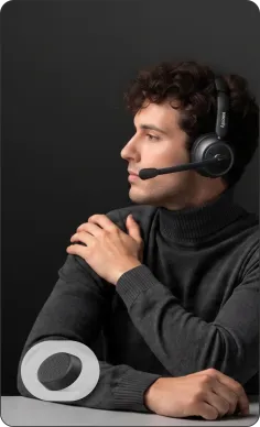 Smiling professional woman comfortably wearing over ear noise cancelling headphones, ideal headphone for call center.