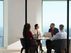 people meeting in the small huddle room.