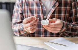 this business man is wondering how to wear his wireless earbuds correctly
