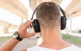 a business man is wondering the question of open back headphones vs closed