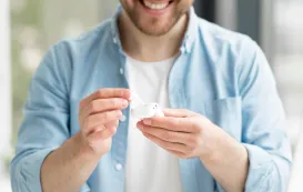 a business man is testing his low latency bluetooth earbuds