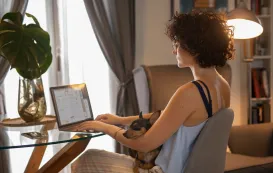 a white woman is using best earbuds for work from home