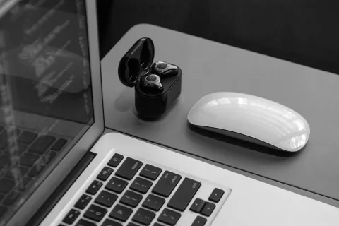 A wireless earbuds for pc near the computer.