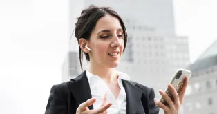 a white woman is talking using wireless earbuds for phone calls