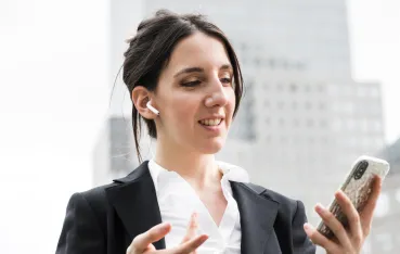 a girl is smiling with wireless earbuds for phone calls on her ear
