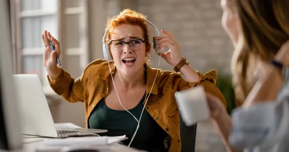 this angry woman is wearing her best headset for noisy office
