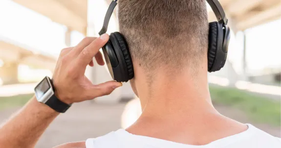 a white man is thinking about the question of open back headphones vs closed