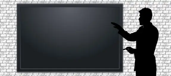 An instructor using an interactive whiteboard to play and annotate a video for a multimedia-rich lesson
