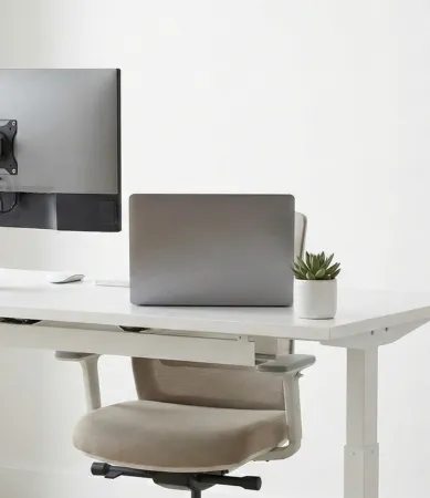 A professional black dual-motor electric standing desk positioned in a high-rise modern office. 