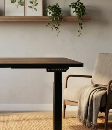 Ergonomic electric standing desk featuring a walnut finish top and digital control panel, shown in a stylish home office environment with warm decor.