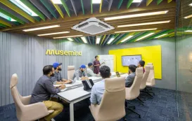 A small team brainstorming ideas together on a small touchscreen