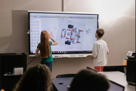 students using an interactive whiteboard in the classroom