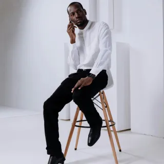 A man sits on saddle seats
