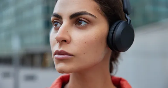 this female is looking ahead with best single ear bluetooth headset for phone calls on her head