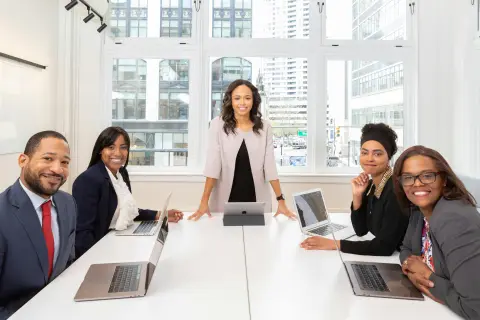 Team members in an office use a white board for a conference room 