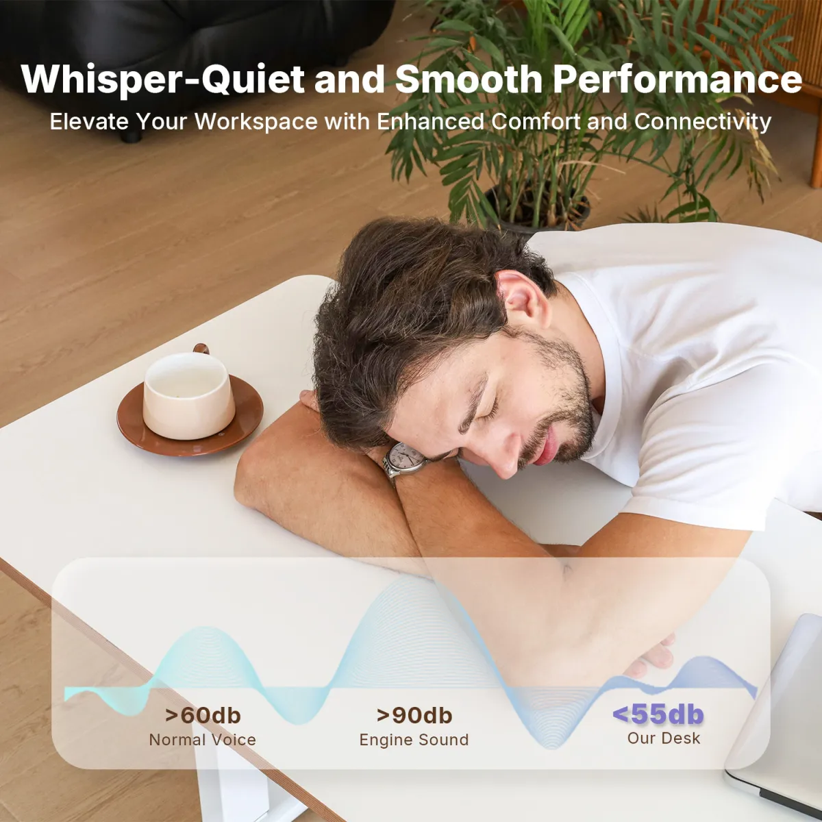 A man is leaning over an adjustable height computer desk