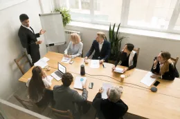 A hybrid team using a wide angle conference camera for a remote meeting.
