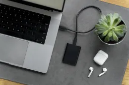Top view of a modern desk arrangement with SSD laptop, showcasing a clean workspace for hybrid work and productivity.