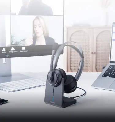 Over ear noise cancelling headphones for work from home set up on a dual-monitor office table.